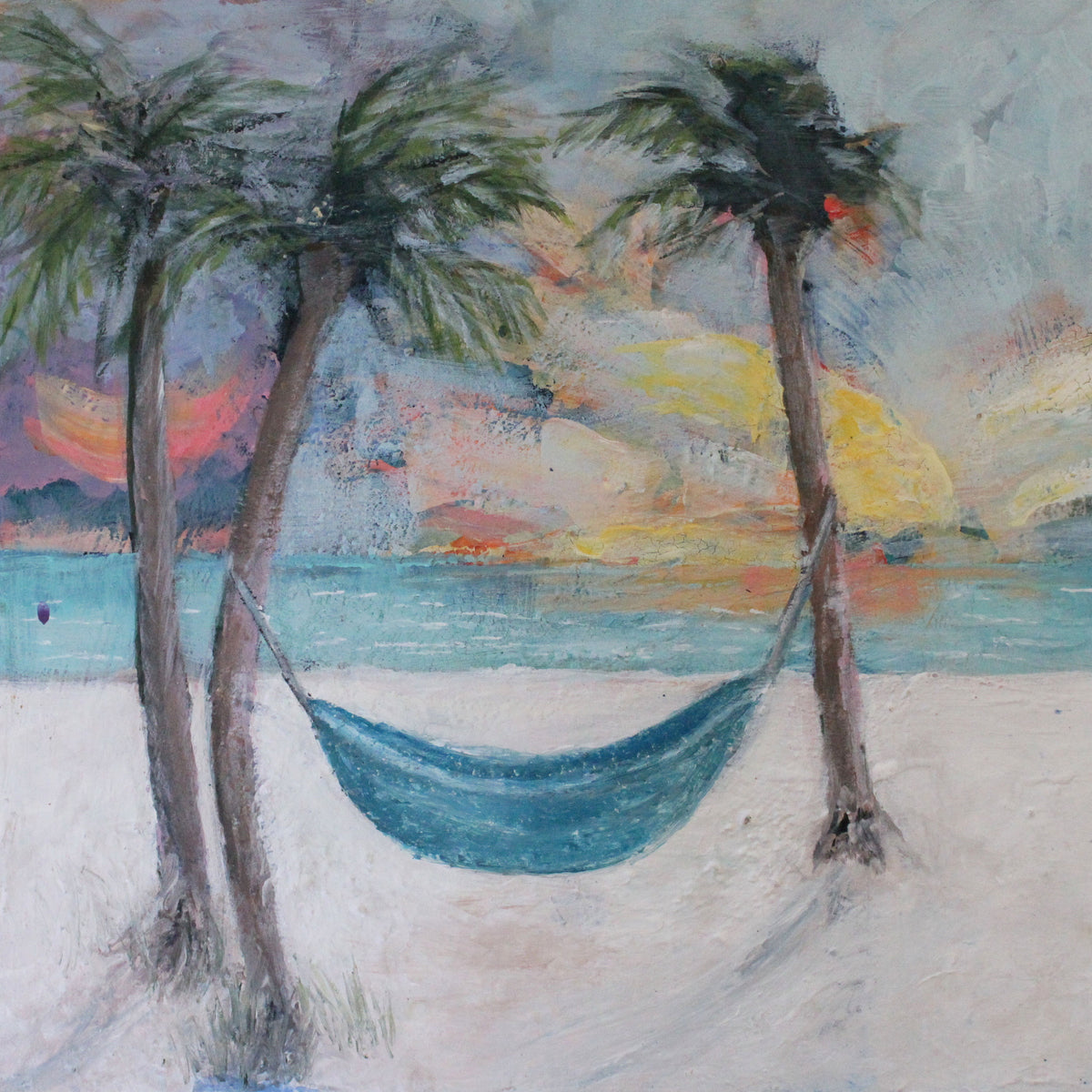 Painting of a hammock between two palm trees on a beach with a colorful sunset.