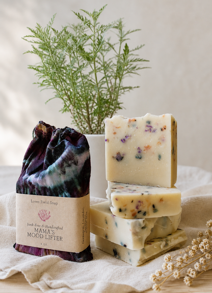 several bars of colorful confetti soap and one soap bar packaged in hand dyed soap bag