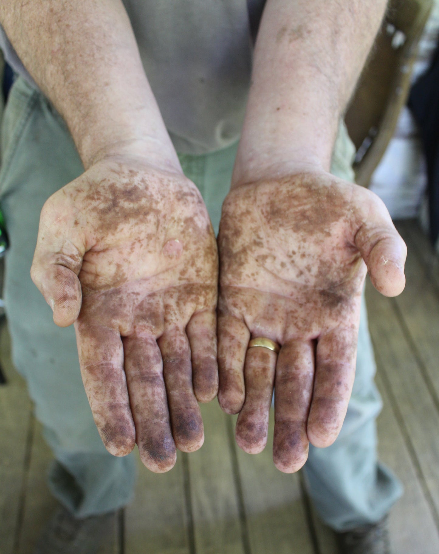 craftsman's hands with handmade orange clove oatmeal exfoliating soap bar