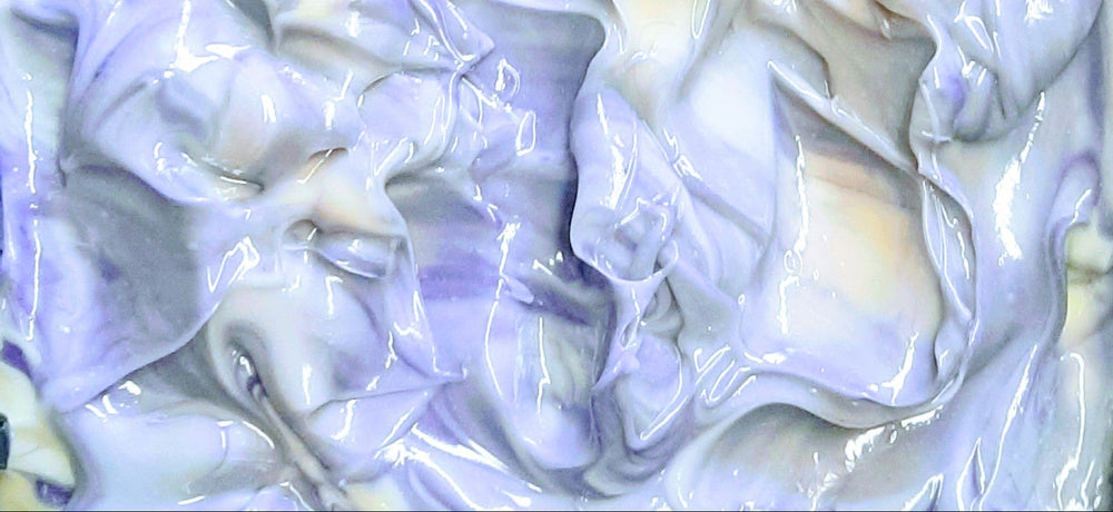 Close-up of a block of white soap with purple swirls.